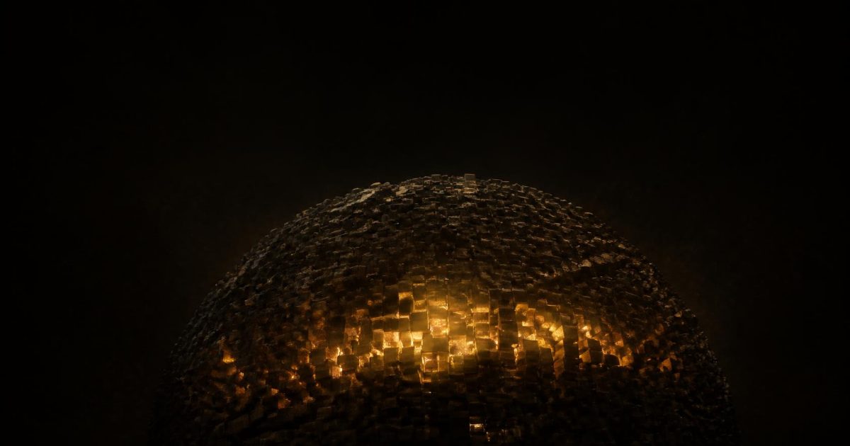 A vast dark sphere built from thousands of tiny cubes, with only a narrow band glowing amber from within on near-black